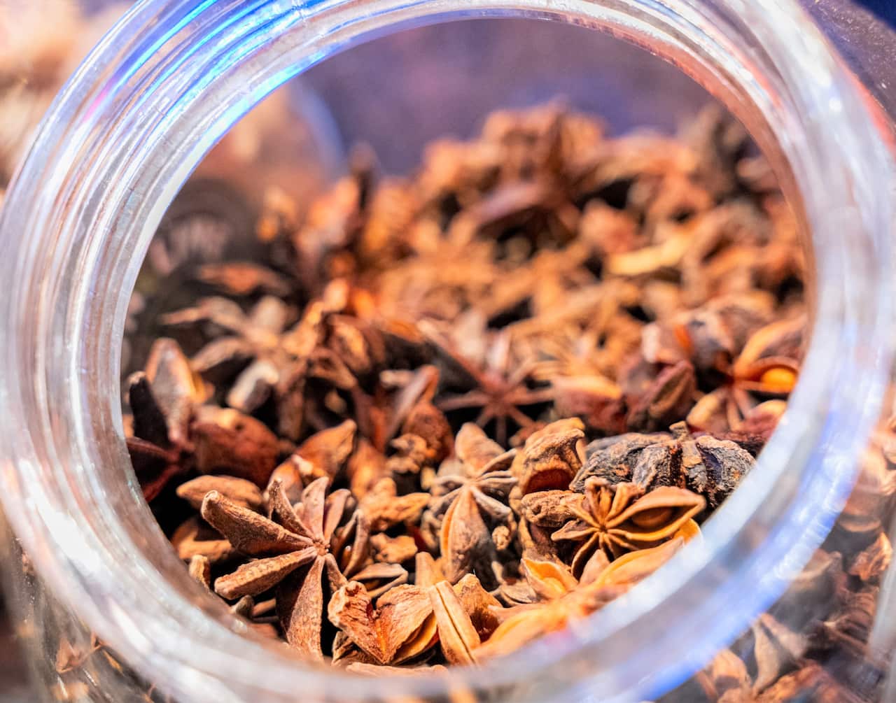 Spices sit in a glass bowl ready to be added to tea to make chai.