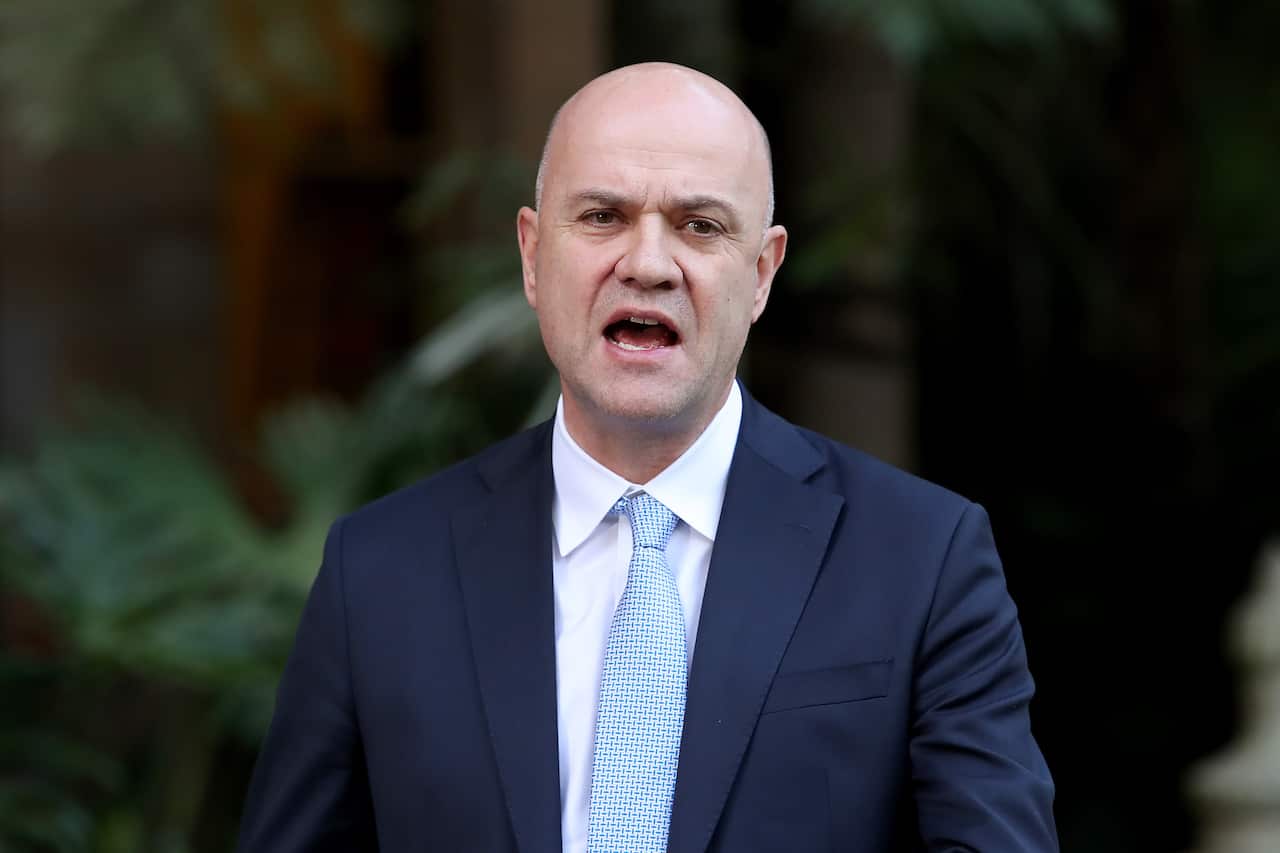 A man speaks outside to reporters