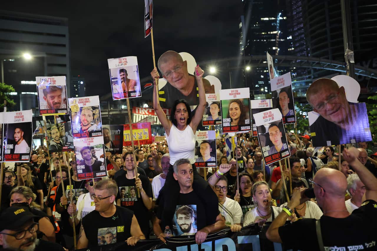 Families of Israeli hostages held by Hamas in Gaza and their supporters attend a protest calling on the government to sign a hostages release and ceasefire deal, outside the Kirya military headquarters in Tel Aviv