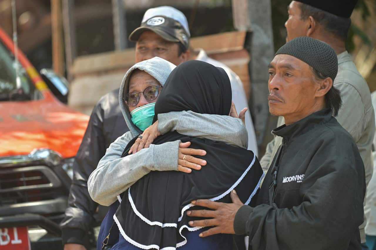 Relatives of missing students embrace as search and rescue operations continue