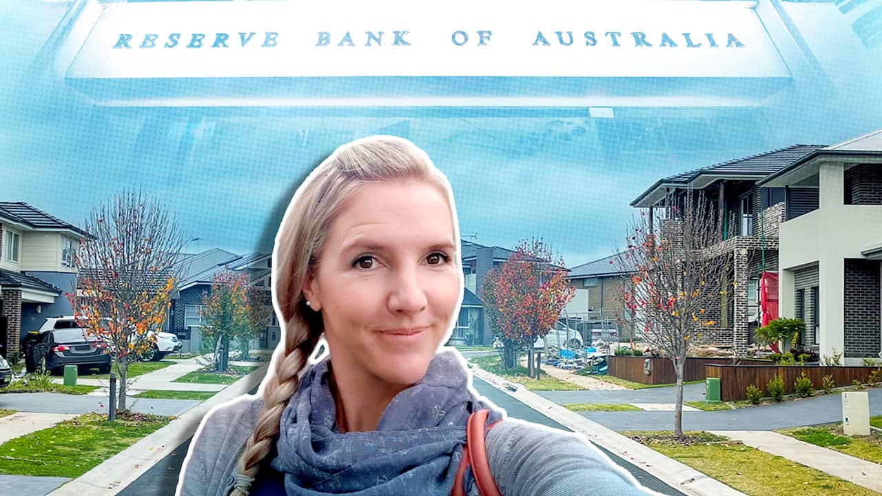 Liv Cotterill pictured in front of houses and an RBA logo