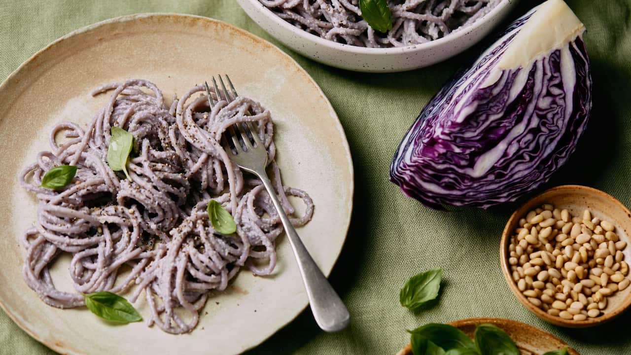 A plate of purple pesto pasta