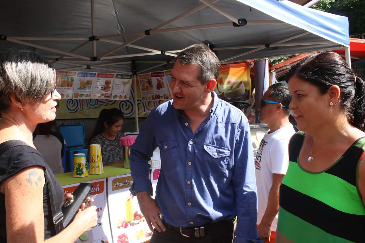 Michael Gunner and Natasha Fyles speak to a local.