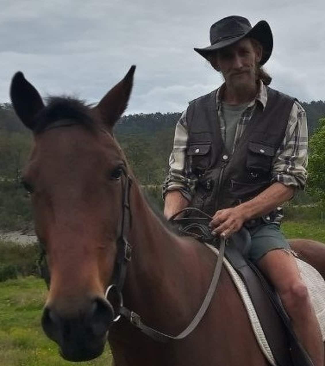 Man in a hat on a horse.