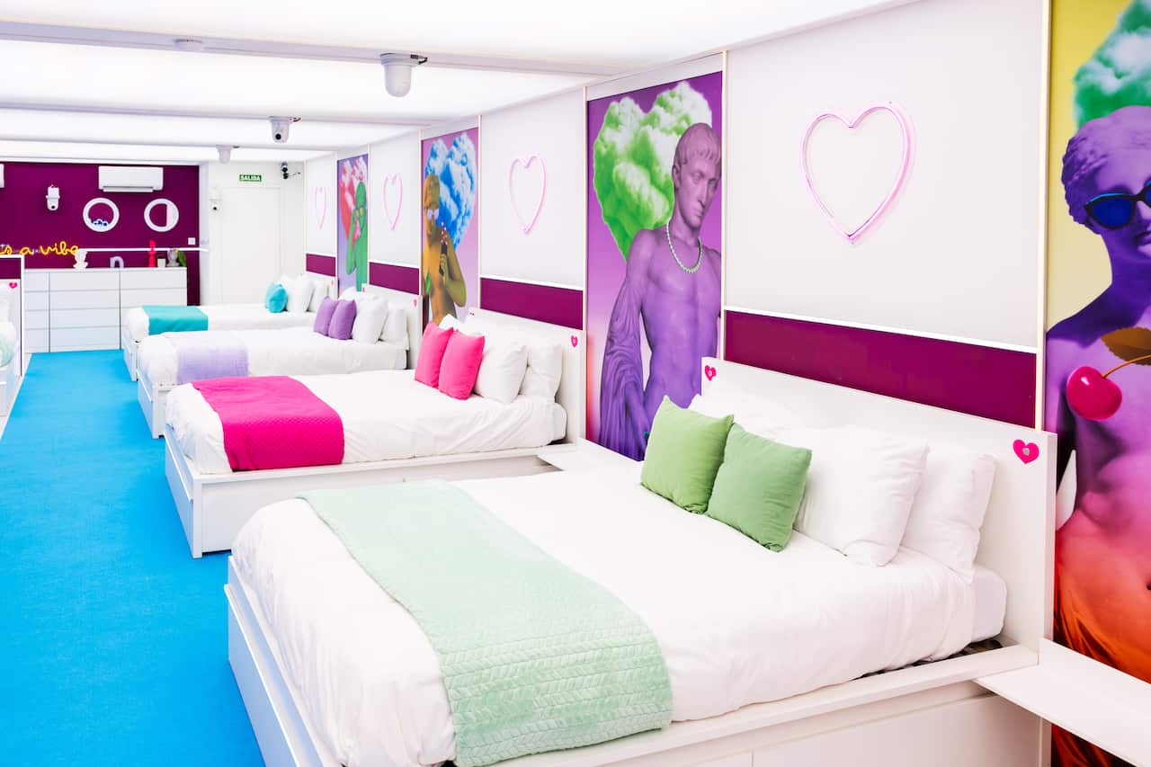 Four double beds in a row in a room