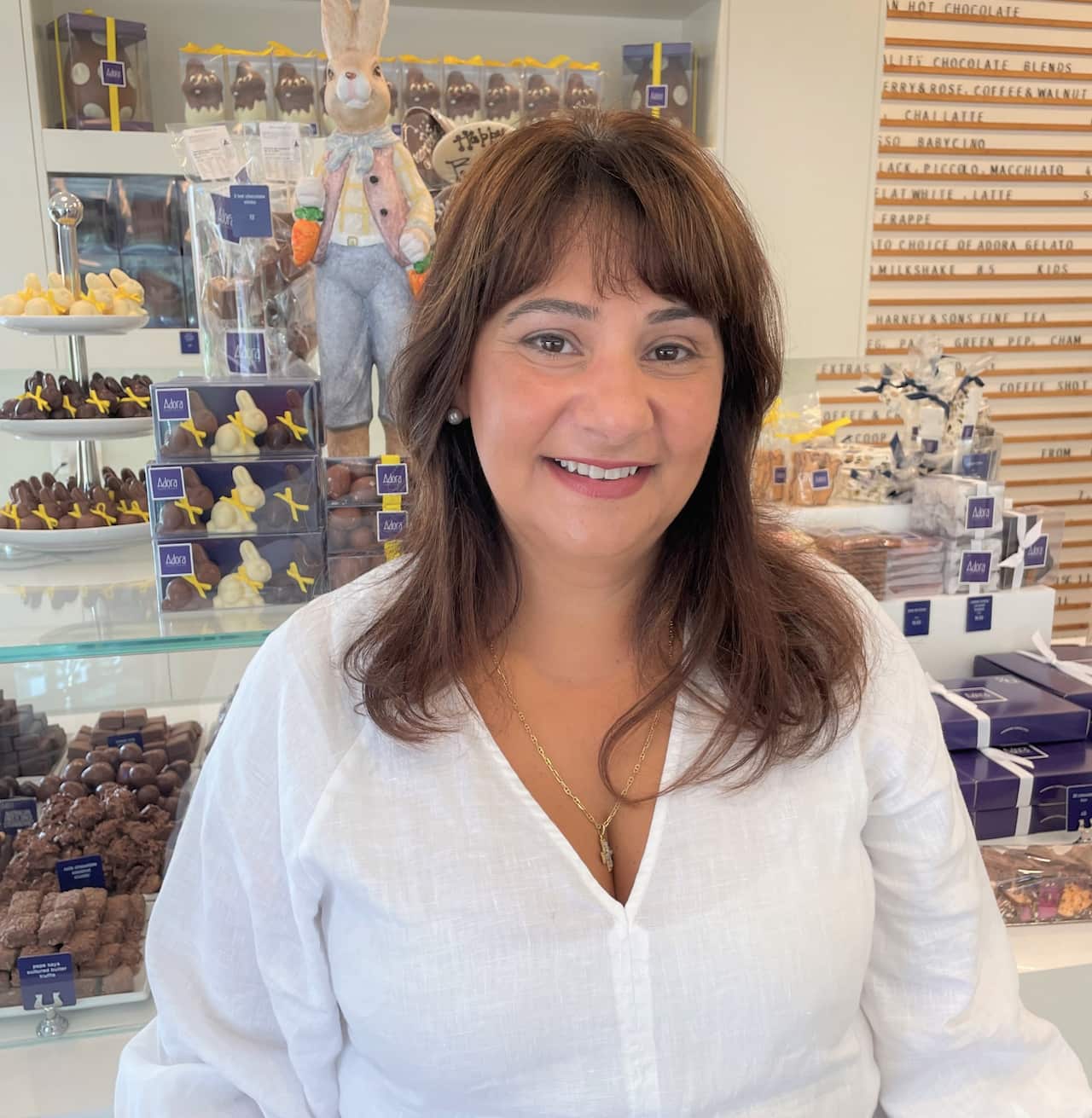 Tina Angelidis standing at the counter of the Adora Earlwood store.