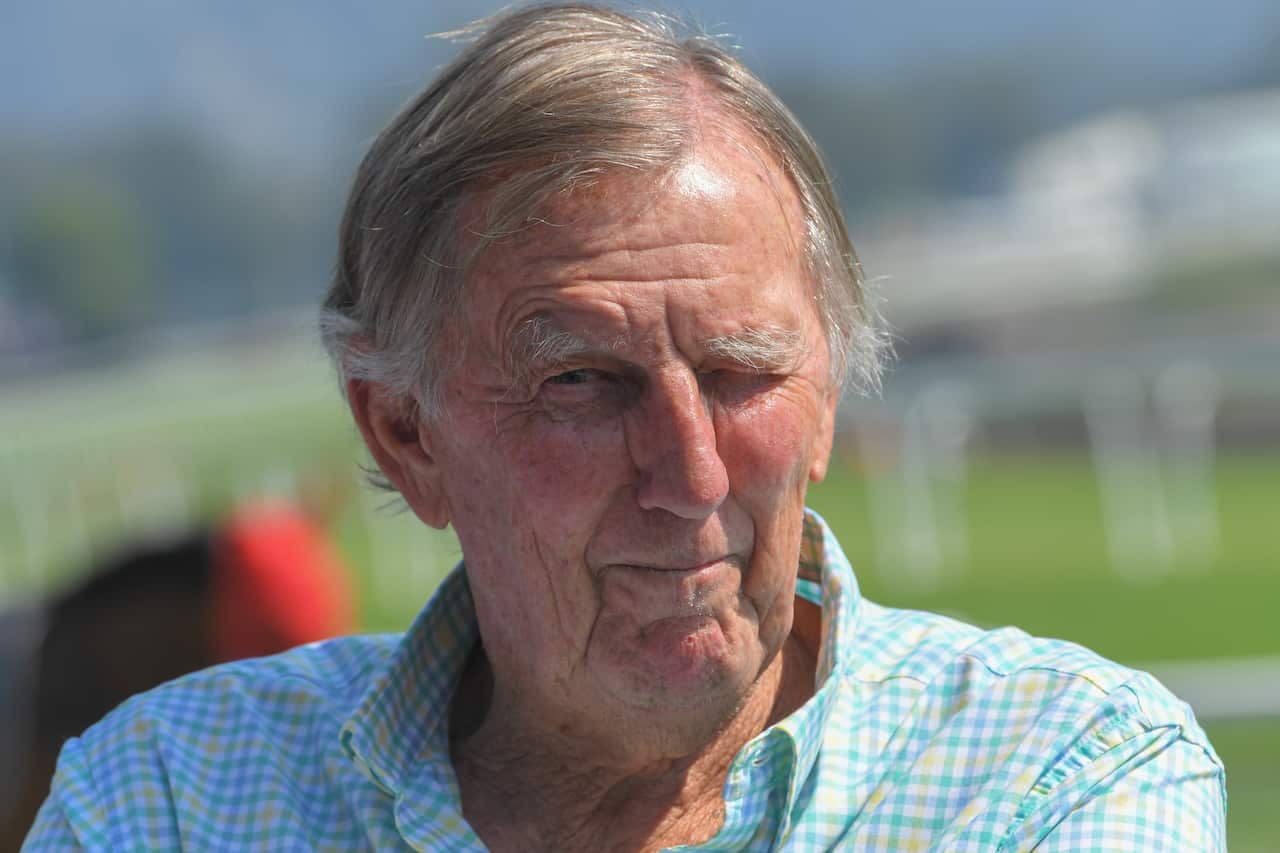 John Singleton wearing a check shirt outside