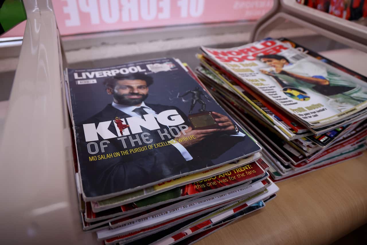 Stacks of football magazines, featuring Liverpool star Mohamed Salah on the cover, sit waiting for customers inside Kleames Dawod's Chatswood barber shop ahead of the Socceroos' World Cup match against Egypt.
