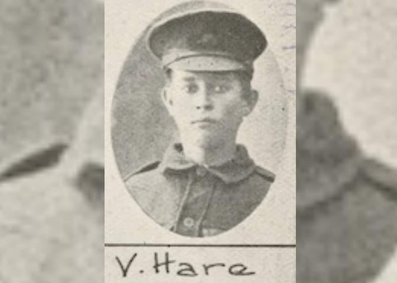 An old black and white photo of a young person in military uniform and hat. It has V.Hare written on it