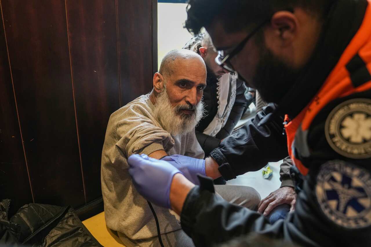 An elderly man being given an medical check up