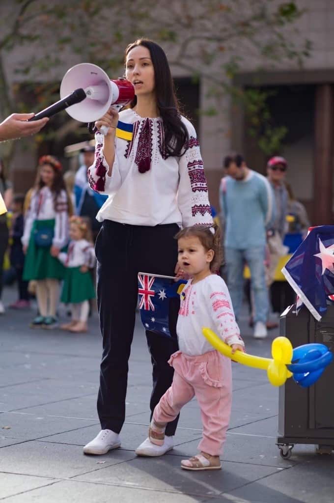 Woman standing with loud speaker.