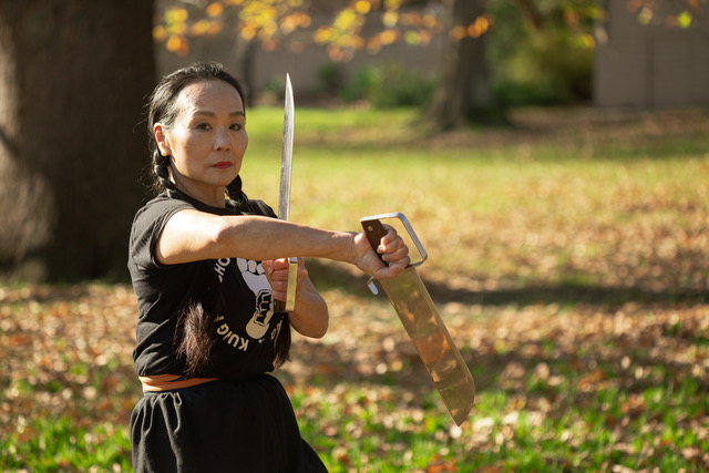 Anne Pang posing with a short sword 