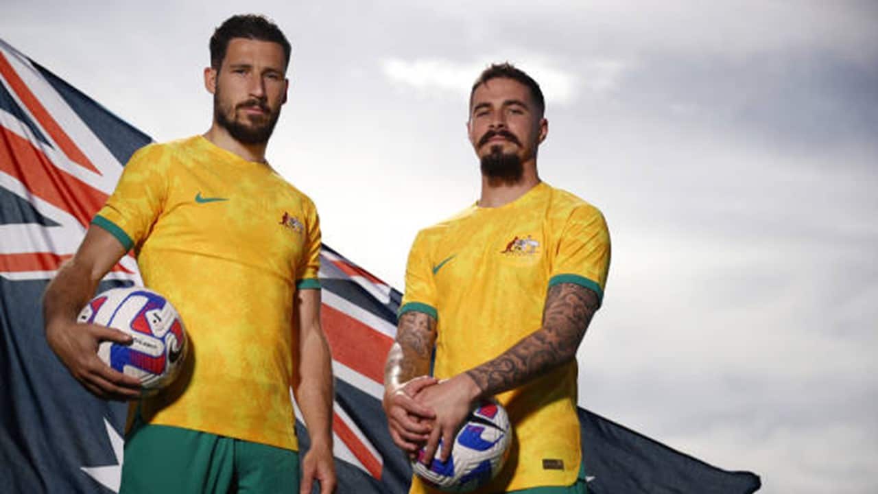 Mathew Leckie and Jamie Maclaren of Melbourne City pose in the Socceroo kit after they were named as part of the Australian 2022 FIFA World Cup squad.jpg