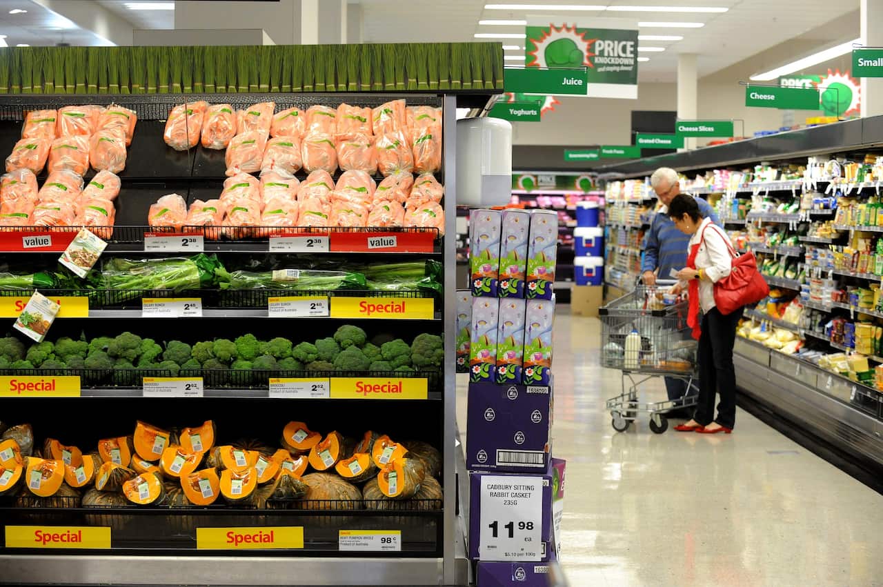 Shoppers are seen browsing the vegetable and dairy produce food aisles.