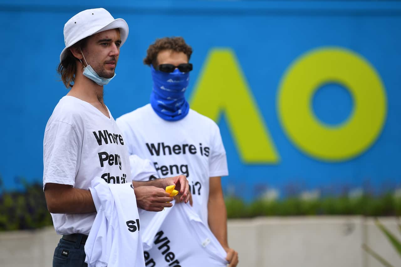 Two people at the Australian Open, wearing t-shirts reading 'Where is Peng Shuai?'