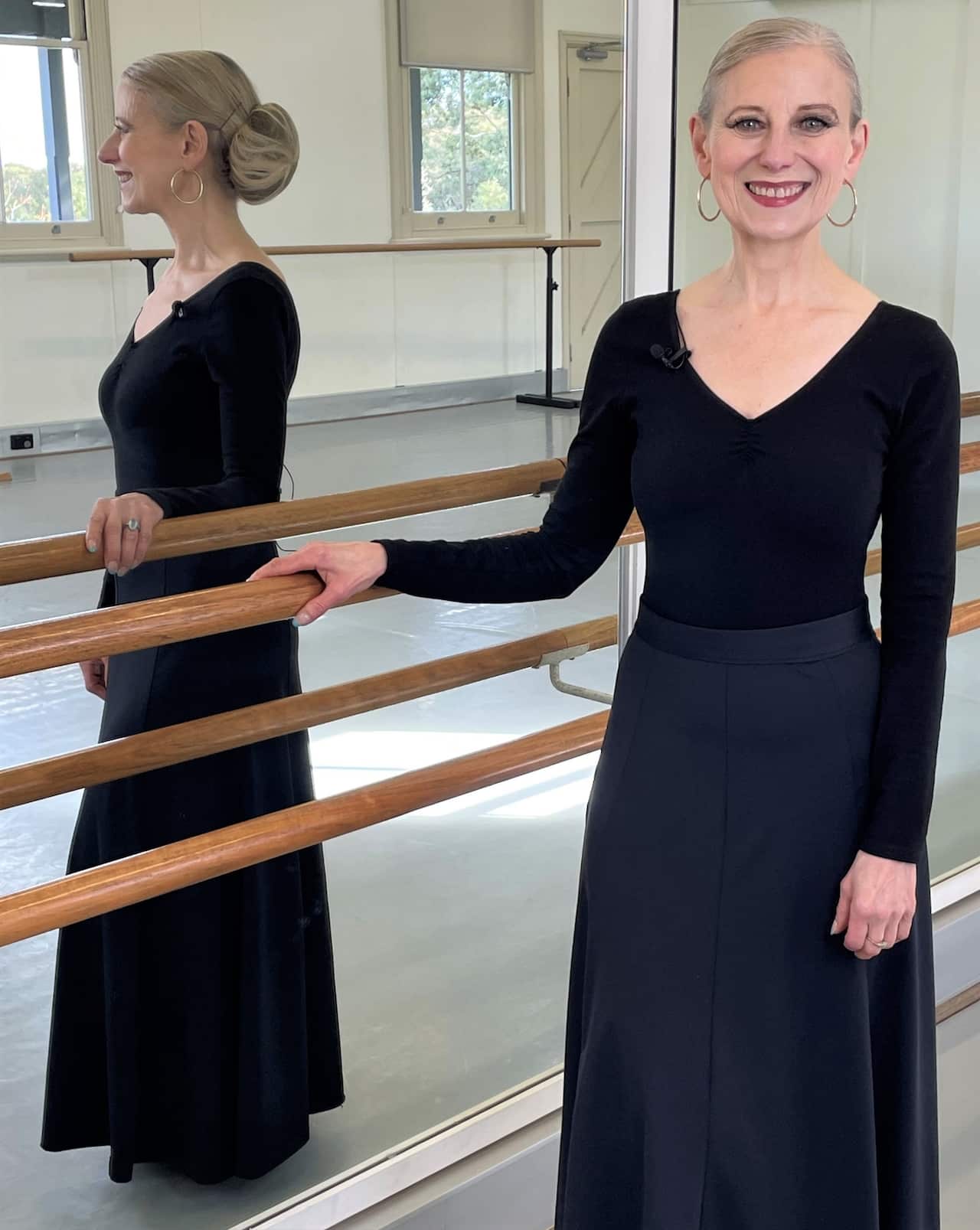 A woman standing in a dance studio.