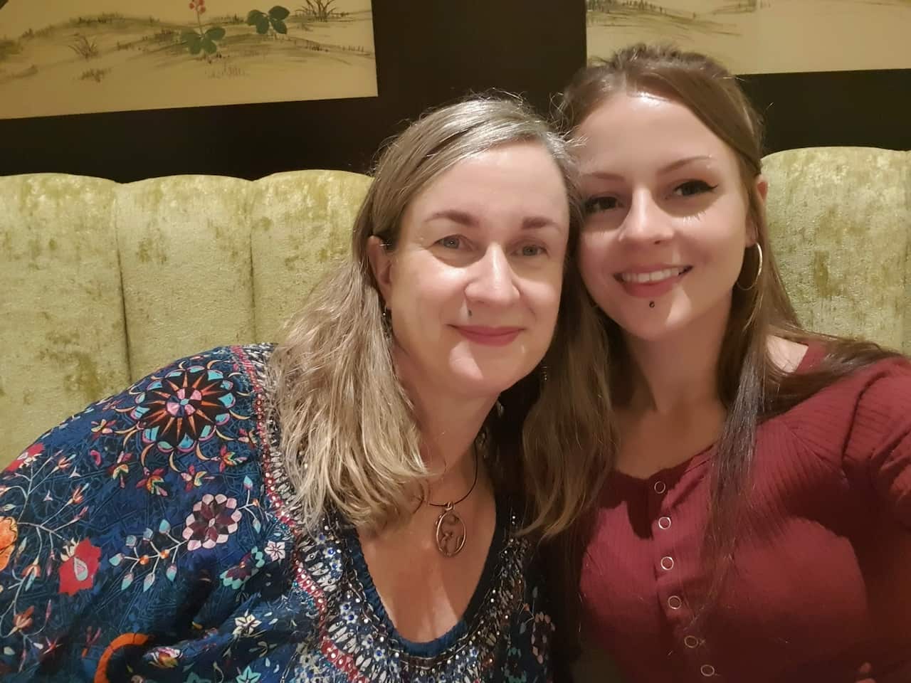 a mother and daughter sitting down 