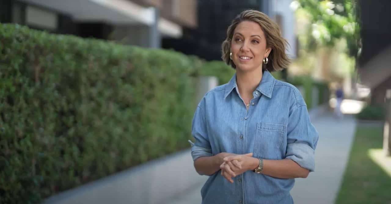 Brooke Boney stands while holding her hands