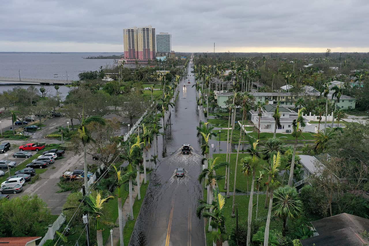 Birds eye view of cars driving through flooded streets