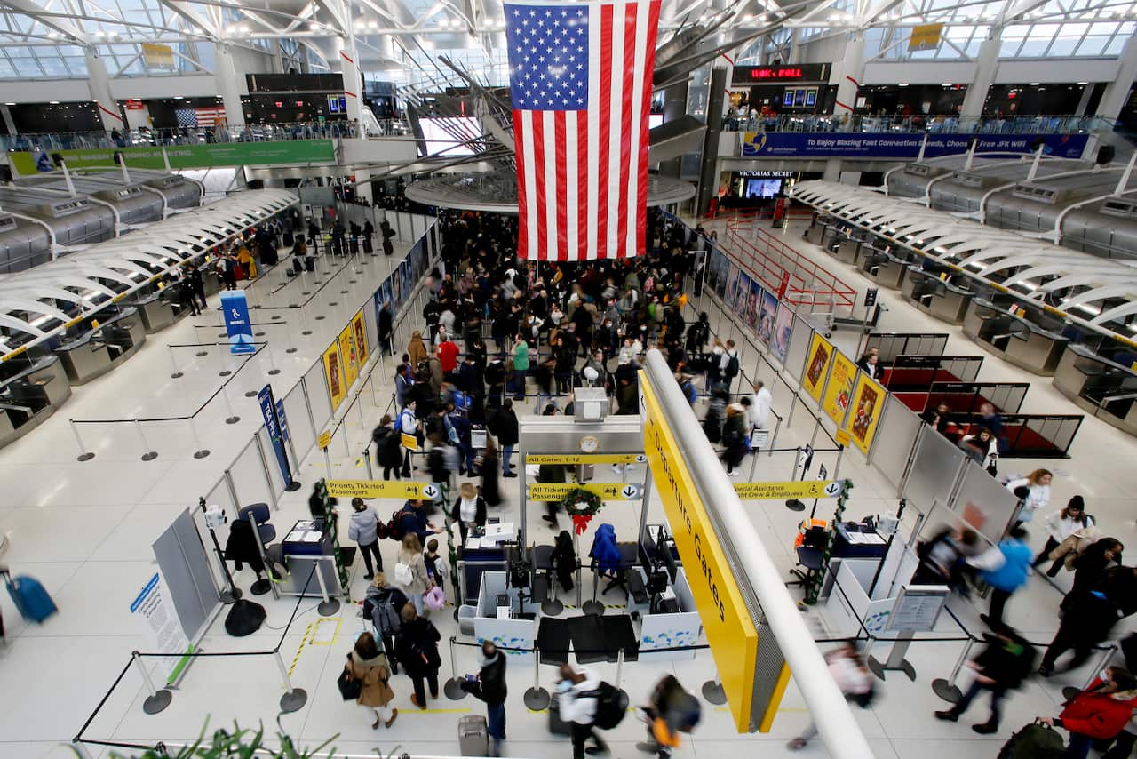 People walking through an airport.