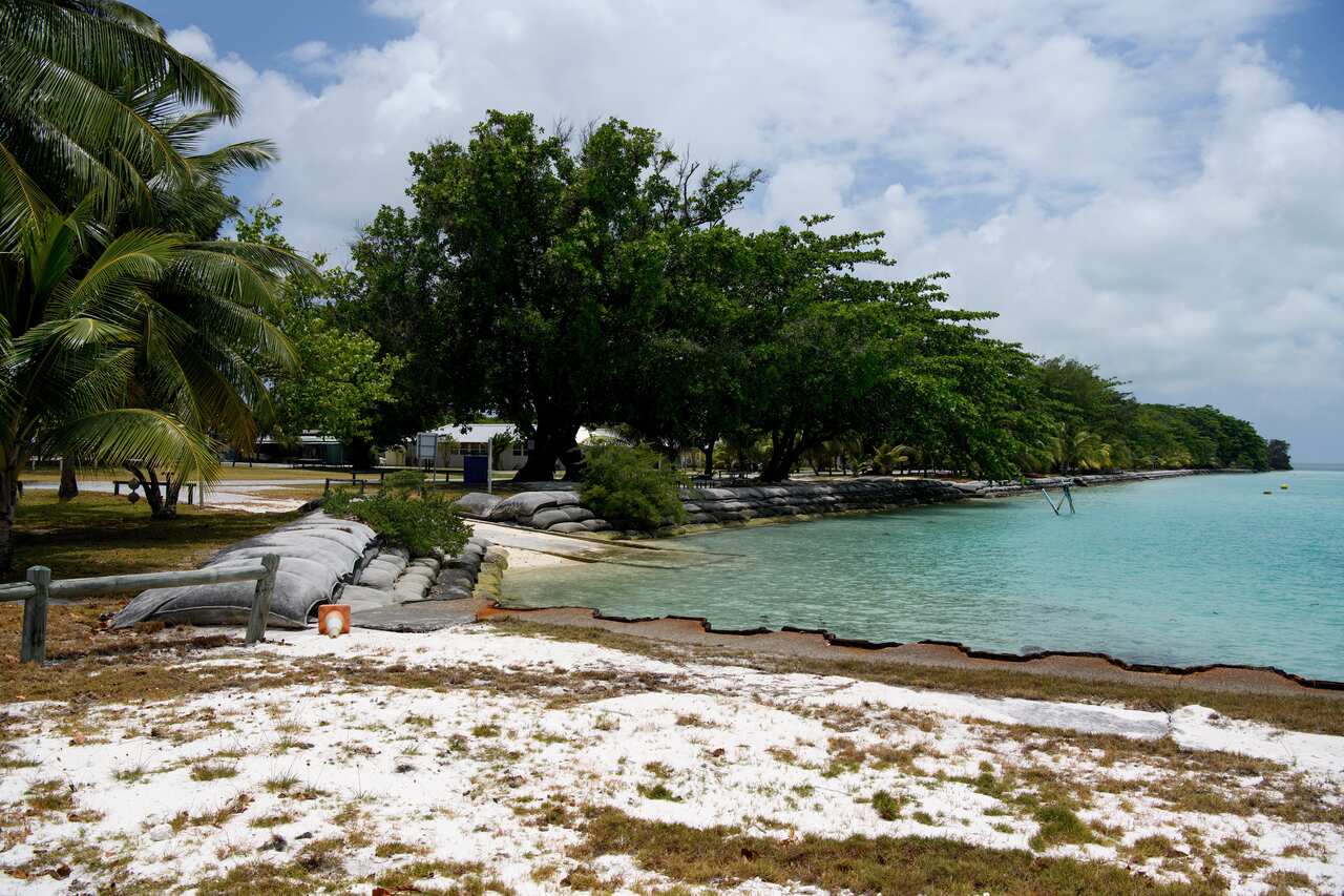 The shoreline of an island, with blue water surrounding it.