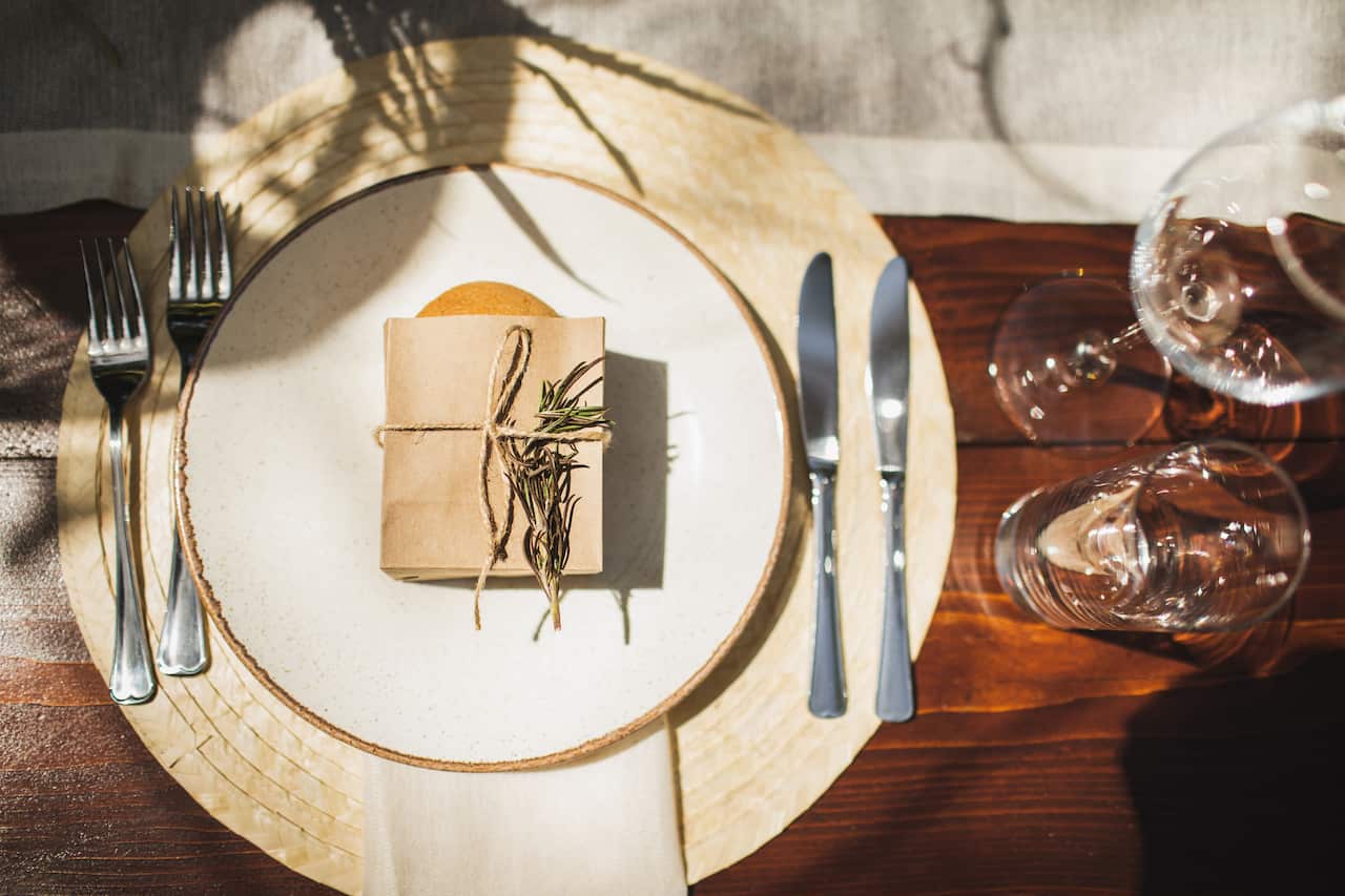 Flat lay of beautiful tableware decorated for evening party in Hampton style table setting. 