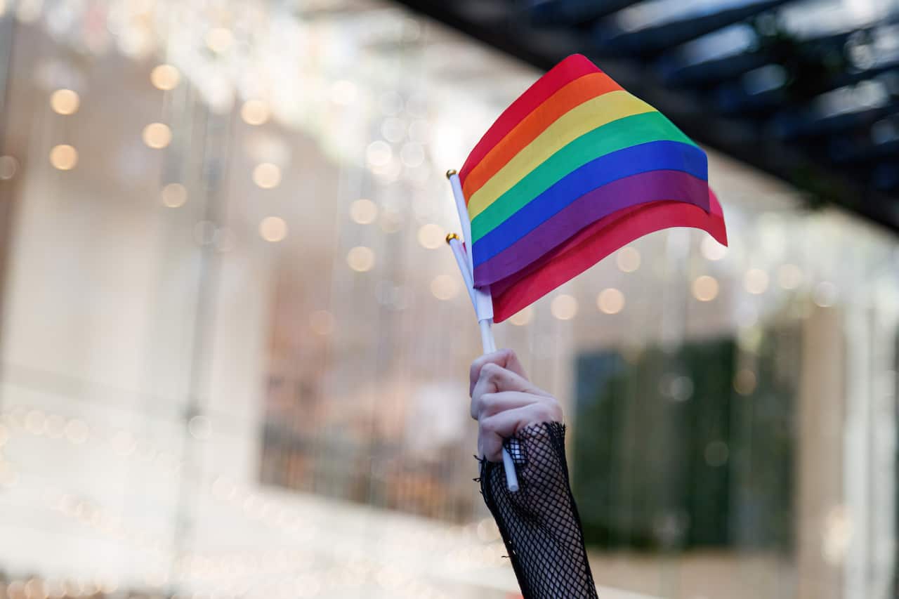 A protester waves the LGBT flag during a demonstration.