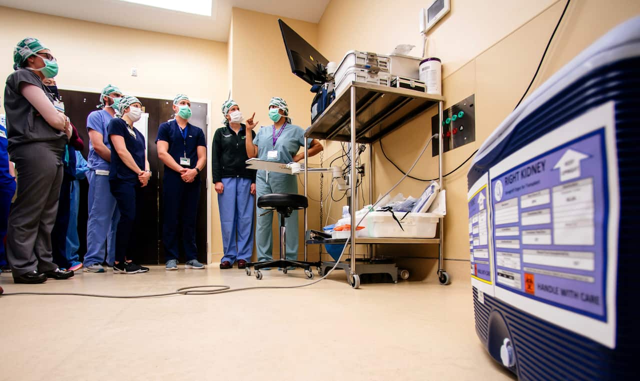 Medical researchers standing in front of medical equipment