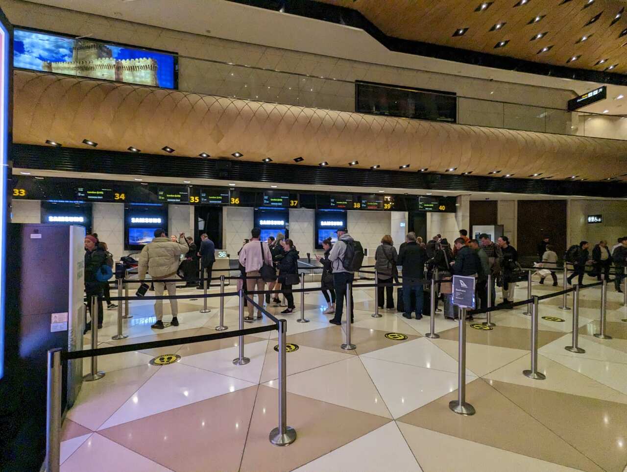 A picture of a queue with people. 