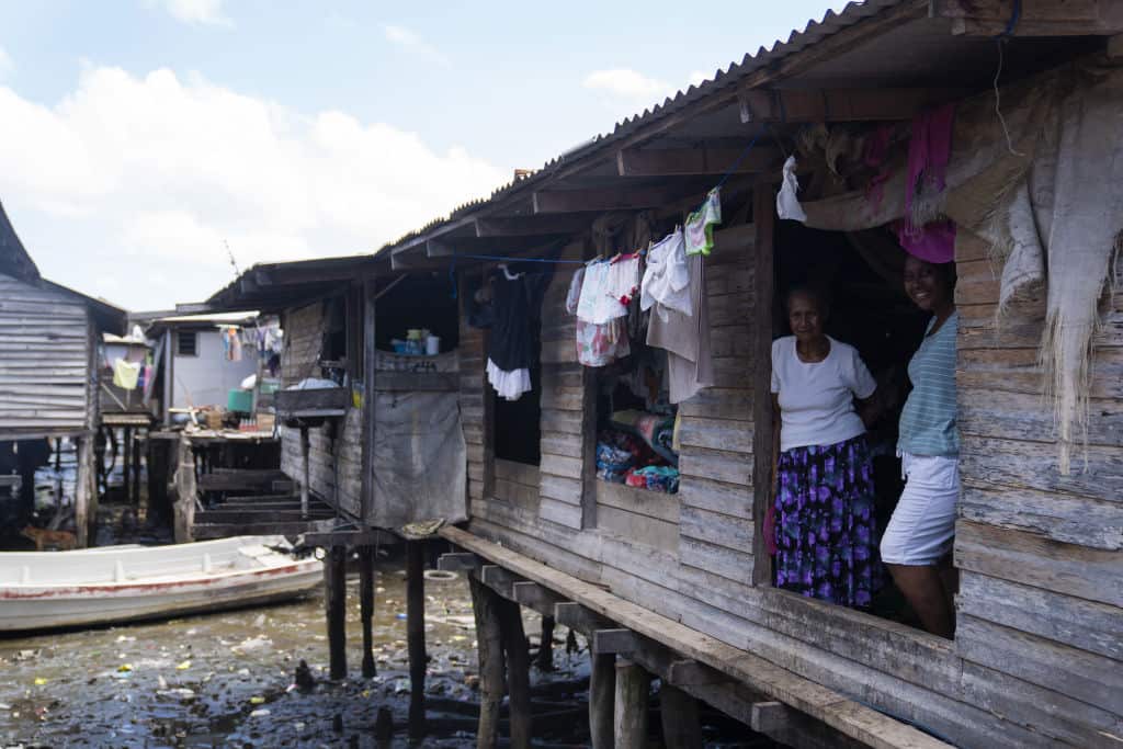 Villagers in a house suspended above water in Papua New Guinea 