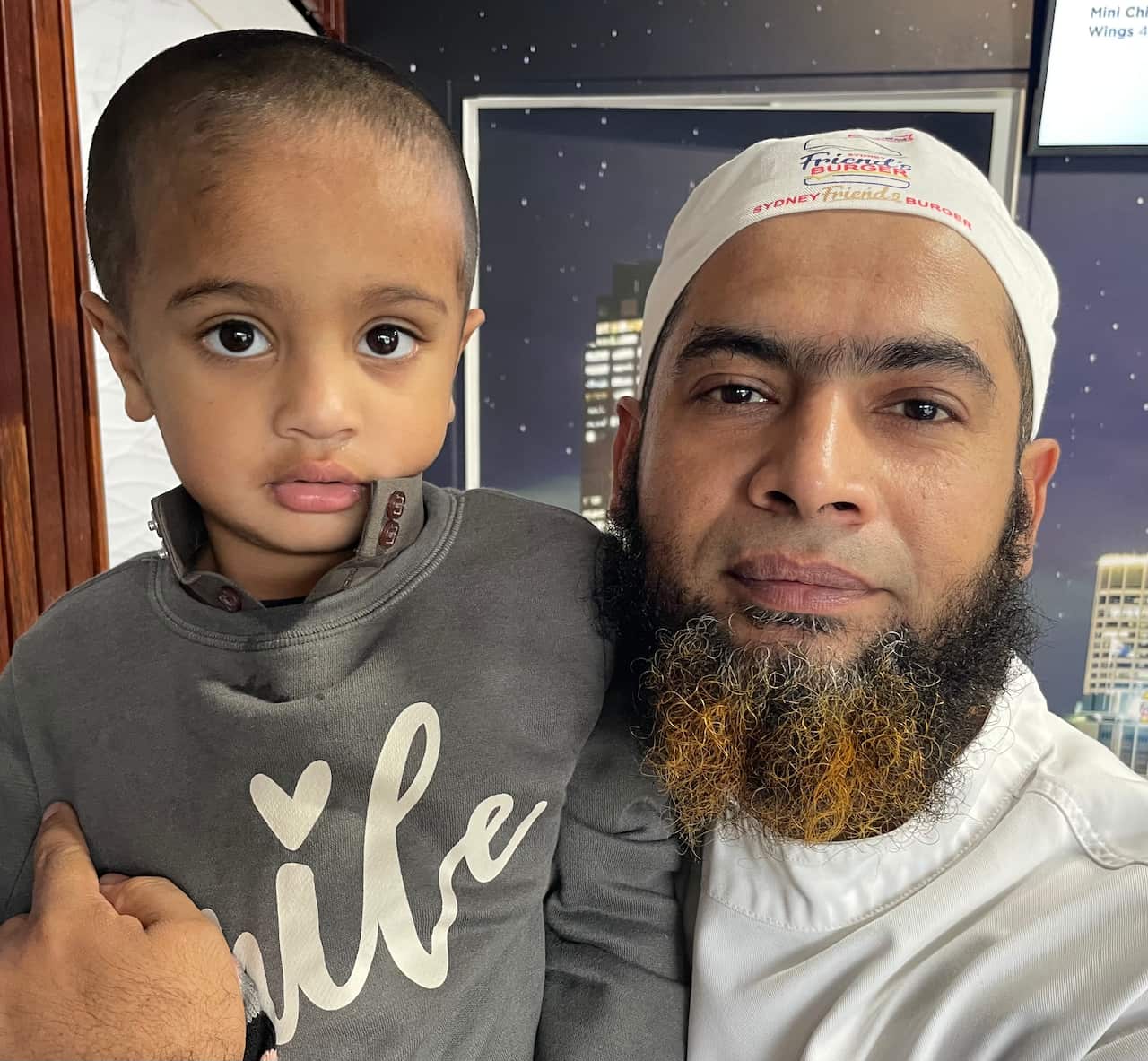 Masum Alam (right) holds his son MD Ali 