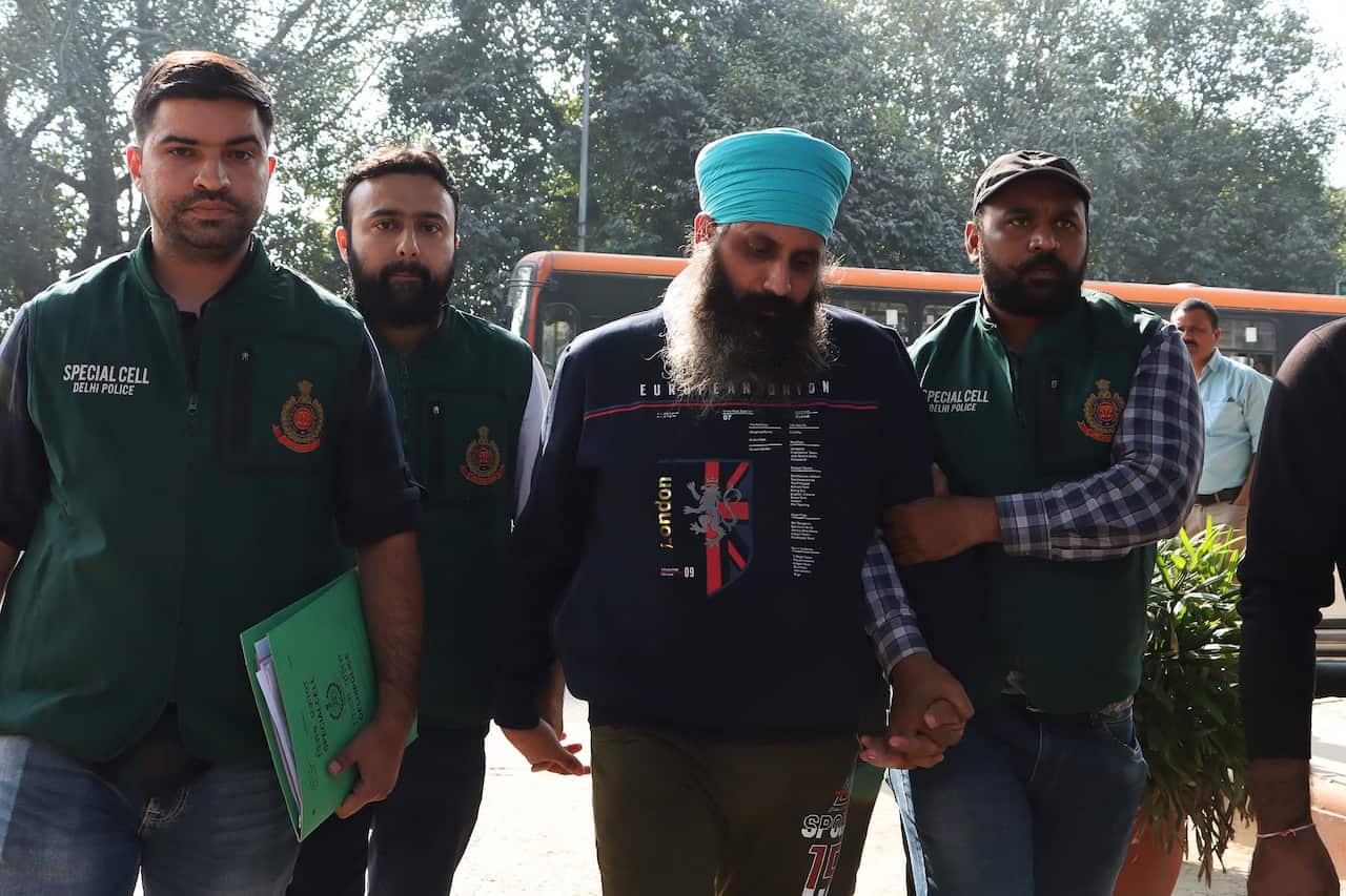 Delhi Police Special Cell officers escort Rajwinder Singh (second from the right) to Patiala court after being arrested in relation to the 2018 murder of Australian national Toyah Cordingley in Queensland.