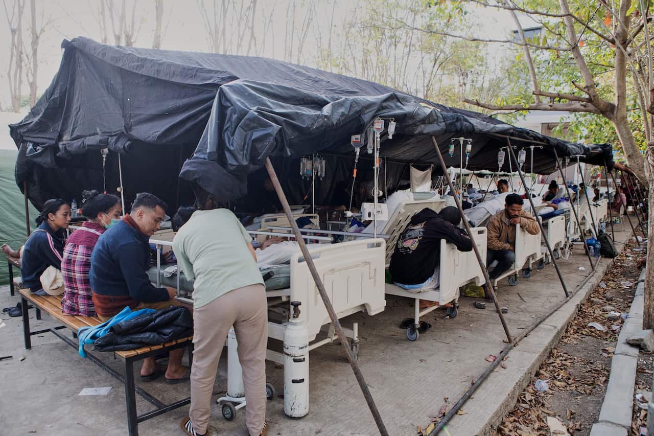 Rows of makeshift hospital beds.