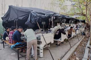 Rows of makeshift hospital beds.