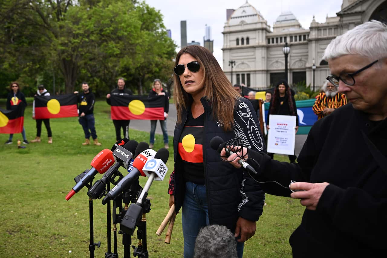 Lidia Thorpe stands in front of microphones outside