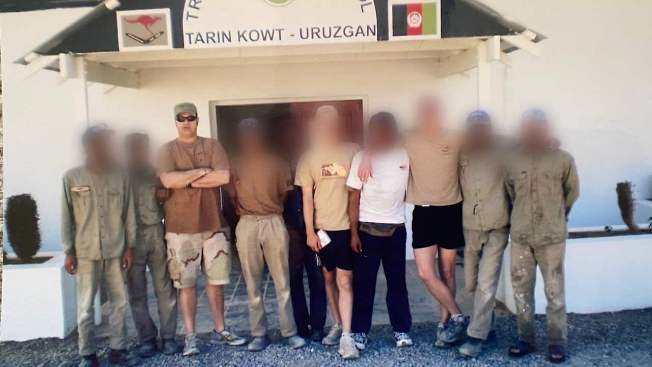 Warren in Afghanistan with his colleagues. The faces of colleagues are blurred. 