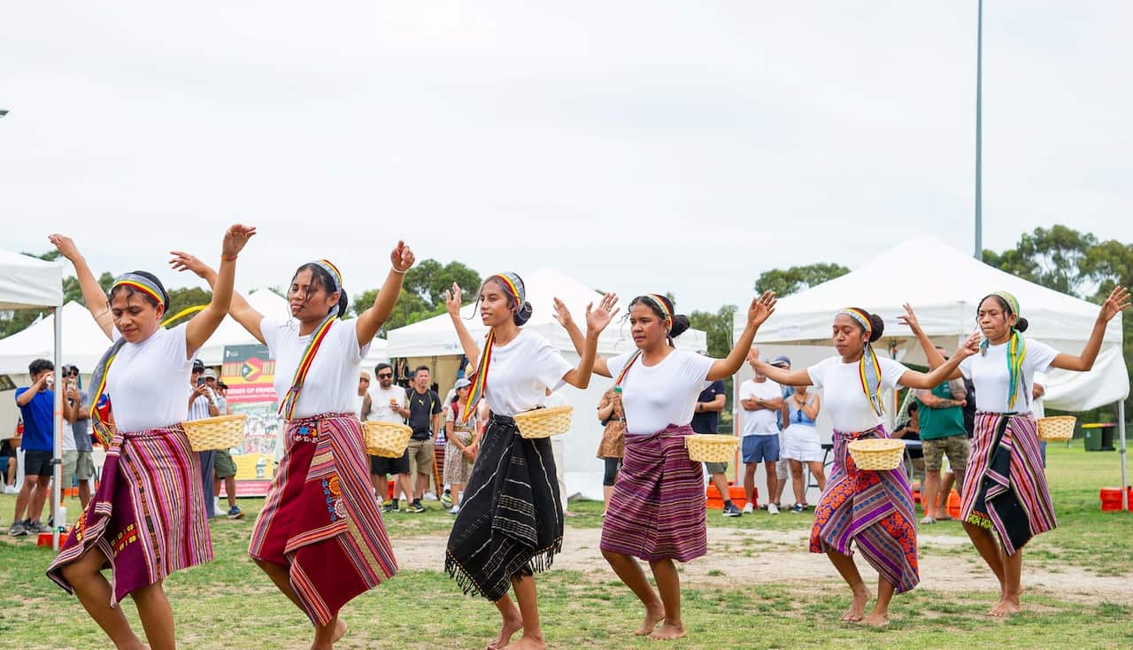 A group of women dancing a traditional Timorese dance.