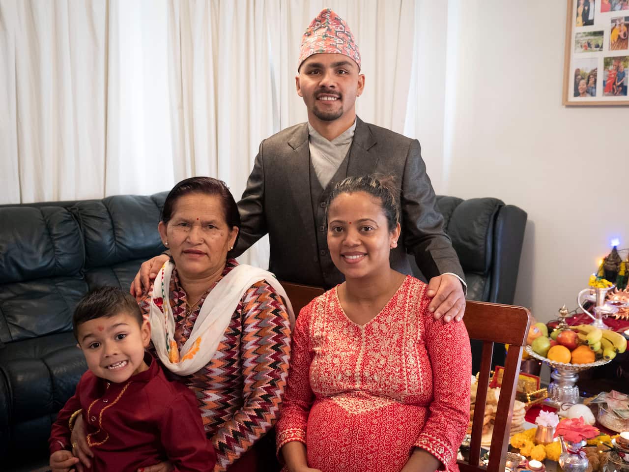 A family of four pose for a photo