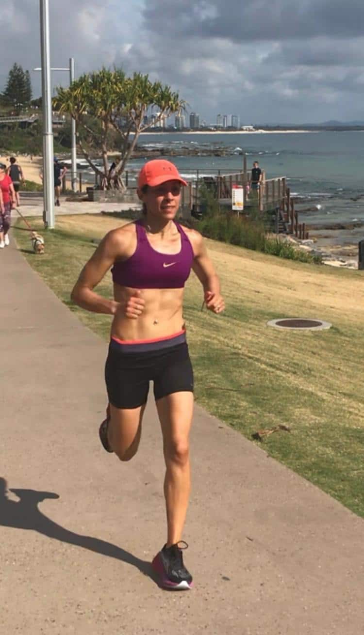 A fit woman running along a path.