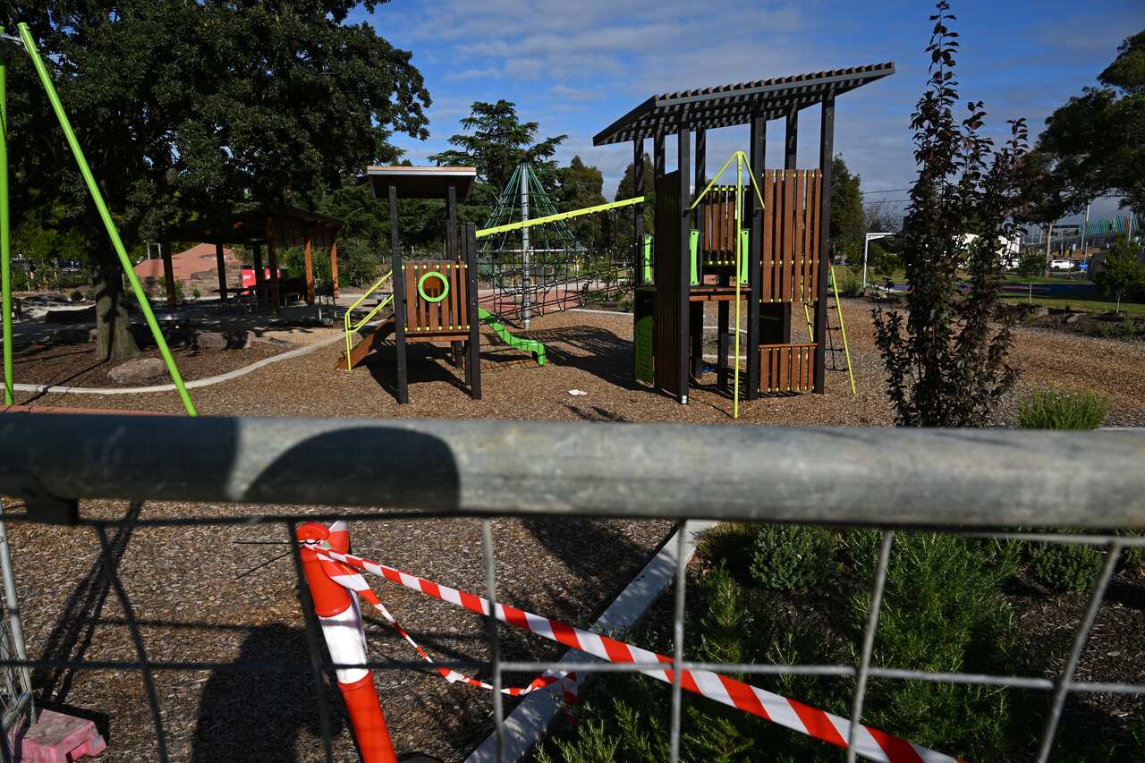A fence and warning tape around a playground