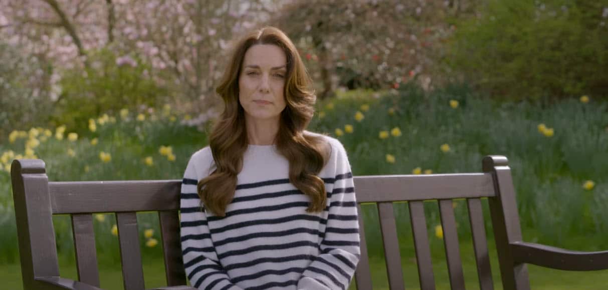 a woman sitting on a park bench