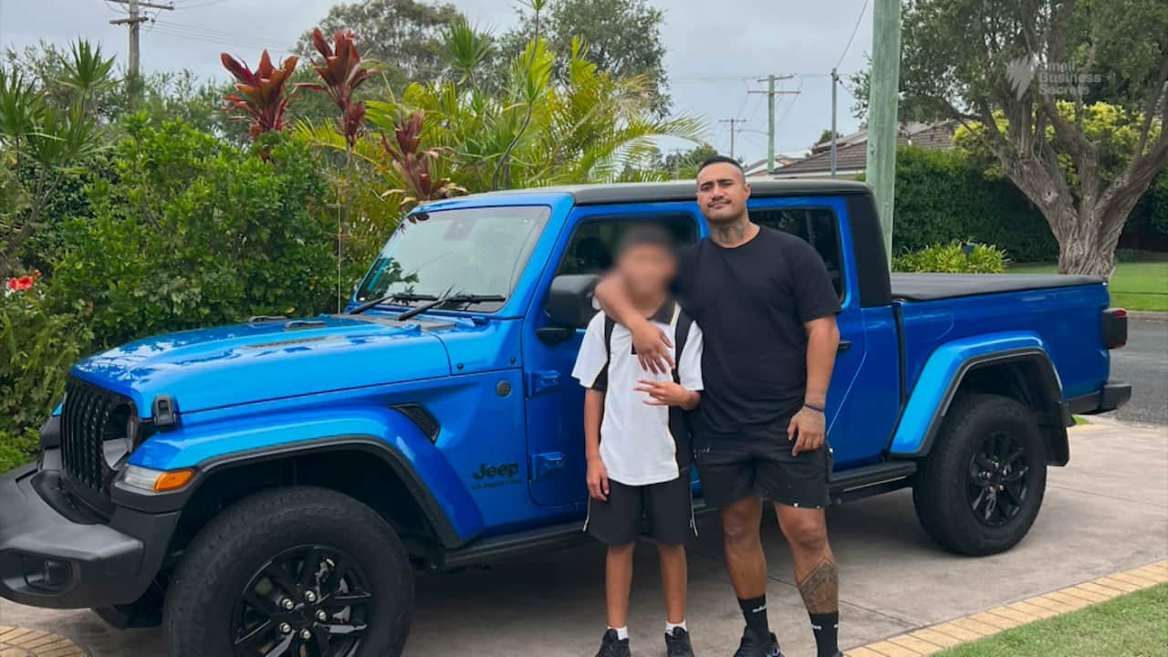 Kinahoi standing with his 12 year old son.