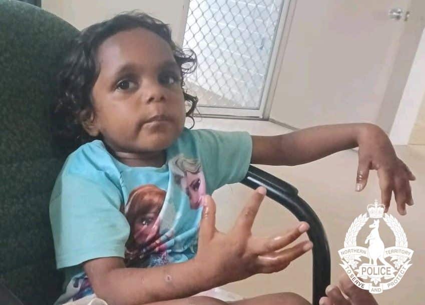 A girl wearing a blue shirt sits in a chair