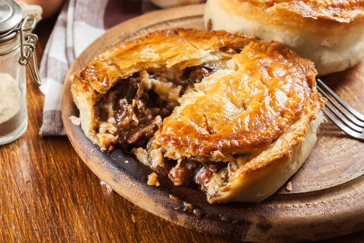 Fresh beef stew pie on a cutting board