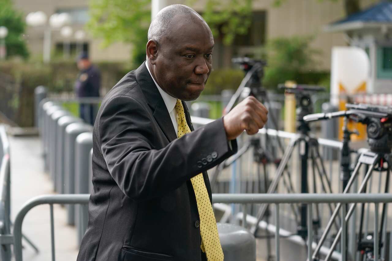 A man wearing a suit and tie who is walking outside.