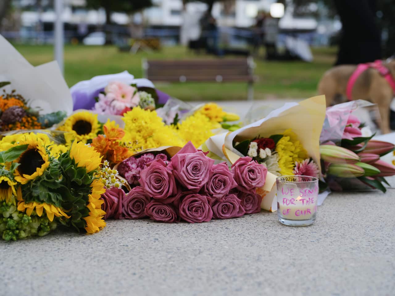 Flowers and candles placed on the ground.