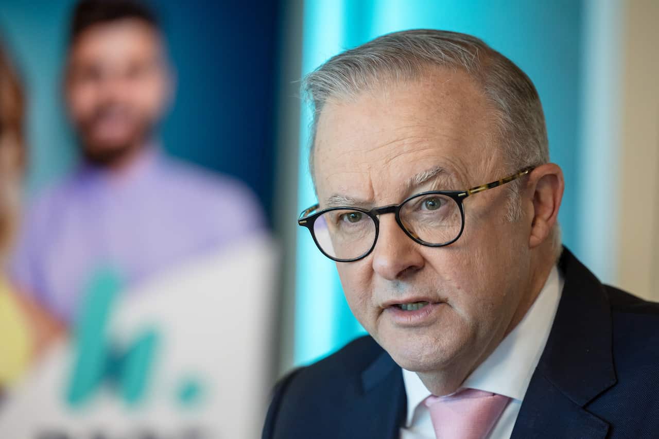 Anthony Albanese in a black suit is speaking.