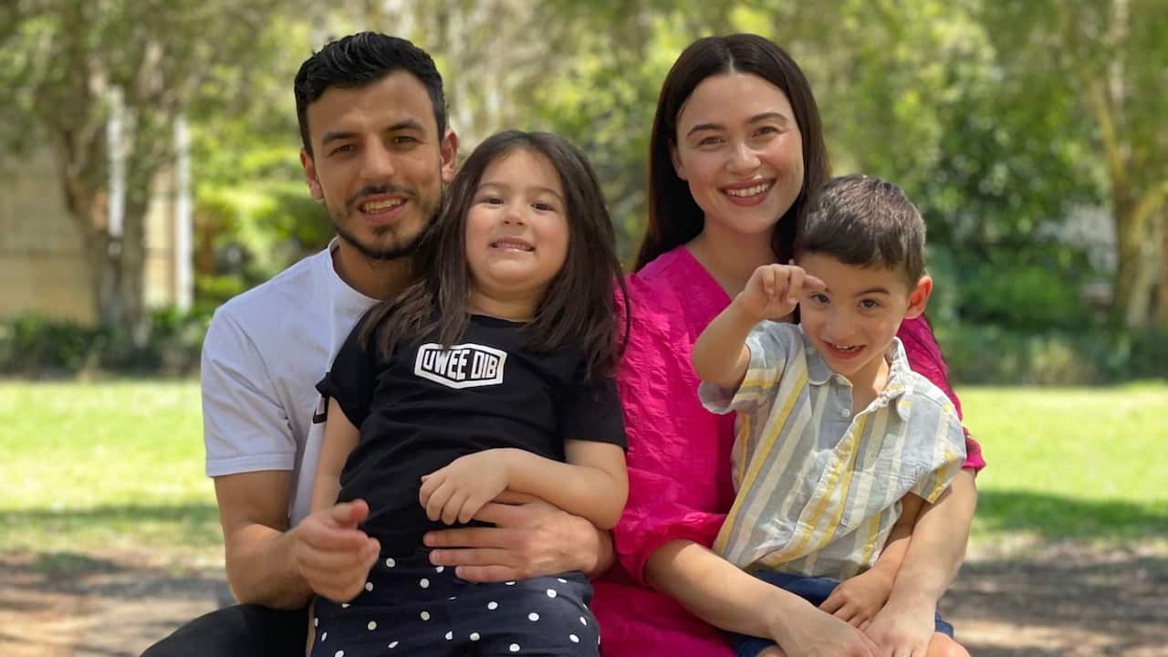 a young family of a man and woman in their 30s with a young girl and boy