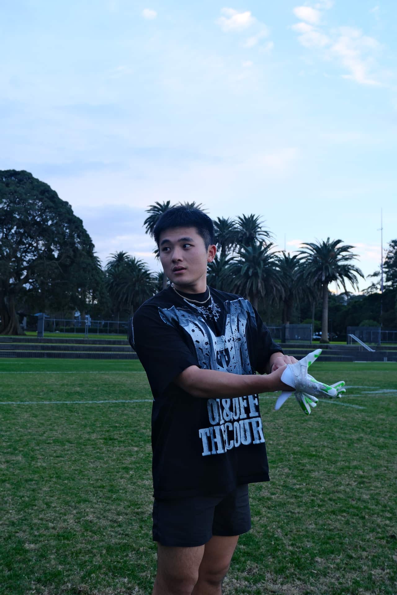 A man puts on gloves.