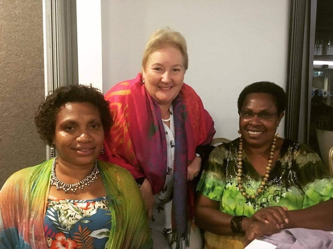 Kessy Sawang (left) and Rufina Peter (right) sitting at a table. 